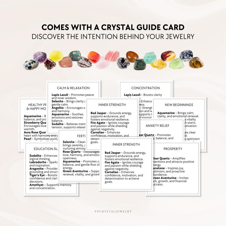 May include: A collection of multicolored polished crystals arranged in a row above several white information cards. The text reads COMES WITH A CRYSTAL GUIDE CARD DISCOVER THE INTENTION BEHIND YOUR JEWELRY and lists various crystal names and meanings.