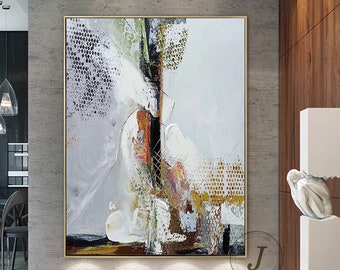 May include: Abstract painting with white, gray, and gold tones. The painting features a large, abstract shape in the center, surrounded by smaller shapes and lines. The painting is framed in a gold frame.