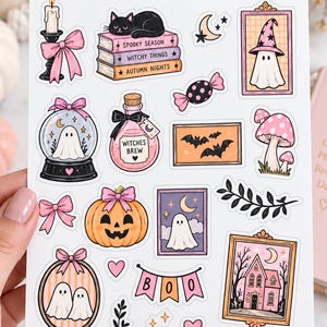 May include: A sticker sheet titled HALLOWEEN SOUL CREEPY CUTE DECOR featuring various illustrations including a black cat on books, a ghost in a snow globe, a potion bottle labelled WITCHES BREW, a pumpkin, a haunted house, and a banner reading BOO.
