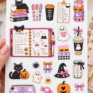May include: A sticker sheet titled PLANNER SOUL SPOOKY PLANS featuring various Halloween-themed illustrations including a black cat on books, a planner, ghosts, pumpkins, washi tape rolls, a witch hat, and a jar labelled SPELLS IDEAS PLANS COFFEE MAGIC.