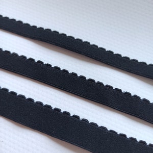 May include: Three pieces of black elastic trim with a scalloped edge.