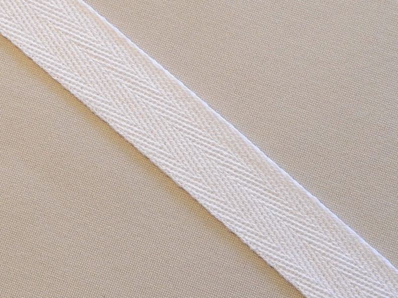 May include: White cotton twill tape with a herringbone pattern.