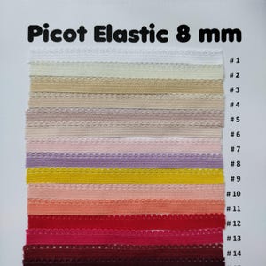 May include: A swatch card of 14 different colors of 8 mm picot elastic. The colors are white, cream, beige, light pink, lavender, yellow, peach, coral, red, pink, burgundy, and brown.
