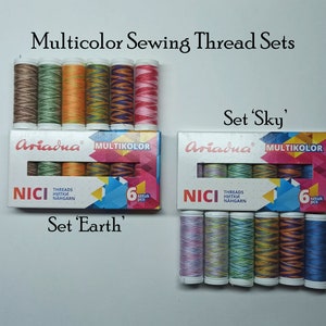 May include: Two sets of six spools of multicolor sewing thread. The spools are labeled "Ariadna" and "Multikolor". The sets are labeled "Set 'Earth'" and "Set 'Sky'".