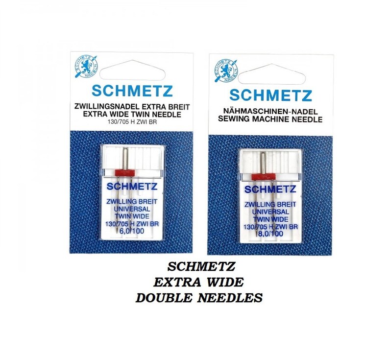 Pode incluir: Dois pacotes de agulhas de m&aacute;quina de costura g&ecirc;meas extra largas Schmetz. Os pacotes s&atilde;o brancos com detalhes azuis e vermelhos. As agulhas s&atilde;o etiquetadas "Schmetz" e "Zwillingsbreit Universal Twin Wide". O pacote &agrave; esquerda tem o tamanho 130/705 H ZWI BR 16.0/100. O pacote &agrave; direita tem o tamanho 130/705 H ZWI BR 18.0/100.