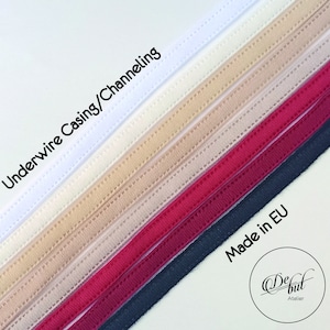 May include: A close-up of seven different colours of underwire casing or channeling for bra making. The colours are white, off-white, beige, light brown, pink, red, and black. The text "Underwire Casing/Channeling" is visible at the top of the image. The text "Made in EU" is visible at the bottom of the image. The text "De but Atelier" is visible at the bottom of the image.