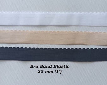 May include: Three strips of bra band elastic in white, nude, and black. The elastic is 1 inch (25 mm) wide and has a scalloped edge.
