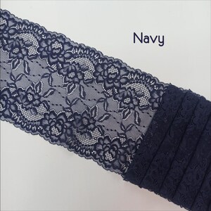 May include: Navy blue lace trim with a floral pattern. The lace is delicate and intricate, with a soft, flowing texture.
