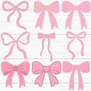 May include: Nine pink bows in diverse designs are displayed. Some bows have long, flowing ribbons, while others feature a heart-shaped centre. The bows are presented against a white wood grain background, offering a clean contrast to the pink.