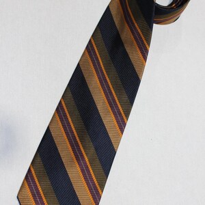 May include: A striped tie with navy blue, brown, orange, and purple stripes.