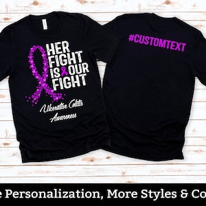 May include: Black t-shirt with a purple ribbon and hearts design. The text "HER FIGHT IS OUR FIGHT" is printed on the front. The back of the shirt has the text "#CUSTOMTEXT". The shirt also has the text "Ulcerative Colitis Awareness".