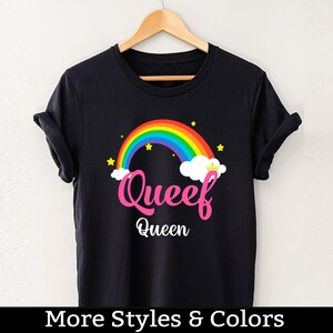May include: Black t-shirt with a rainbow and the text "Queef Queen" printed on it.