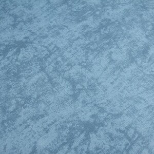 May include: A close-up of a blue textured surface with a subtle pattern. The surface has a rough, uneven texture, giving it a rustic or industrial look.