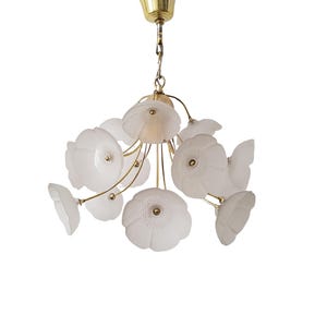 May include: A white glass chandelier with a brass frame and multiple flower-shaped shades.