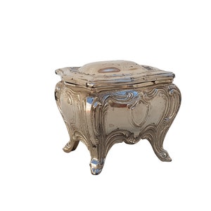 Vintage box on high legs with a lid. Silver box.