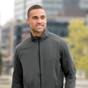 May include: A gray zippered jacket with a stand-up collar. The jacket has a smooth, slightly shiny finish.