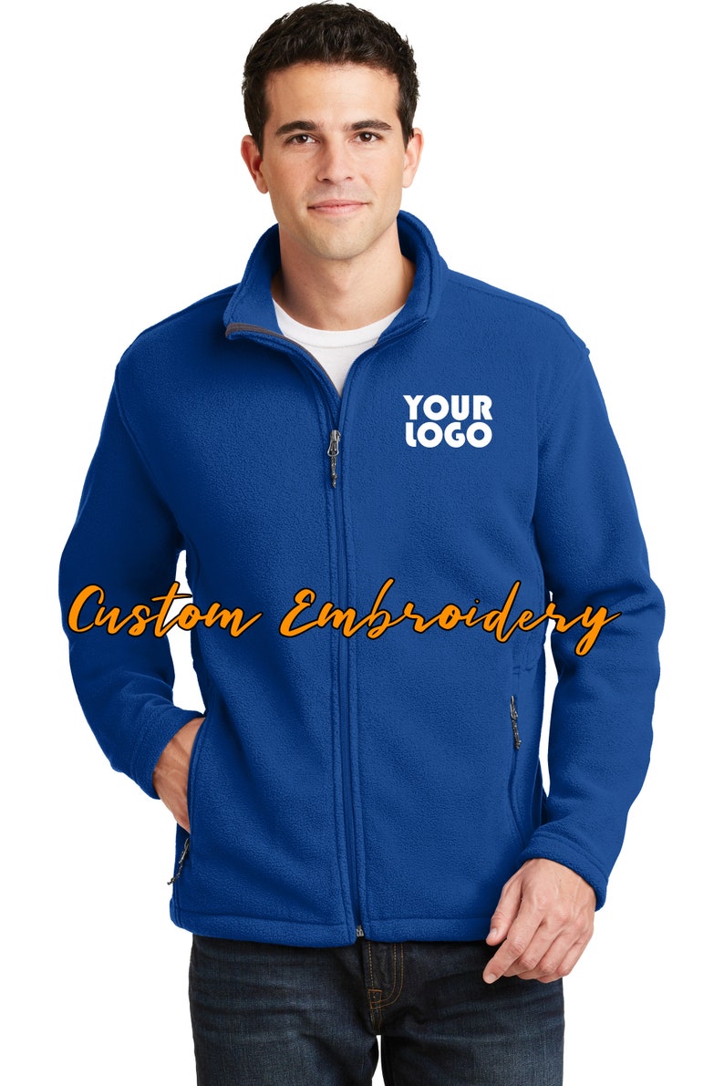 May include: A royal blue fleece jacket with a zipper closure and two front pockets. The jacket has a white embroidered logo that says "YOUR LOGO" on the left chest.