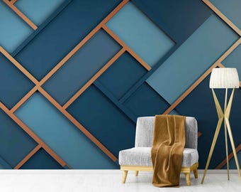 May include: A modern living room interior with a gray armchair and a floor lamp with a white shade. The wall features a geometric pattern of overlapping blue and copper squares.