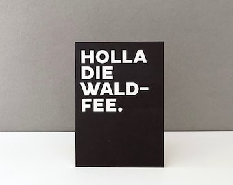 May include: Black card with white text that reads "HOLLA DIE WALD-FEE."