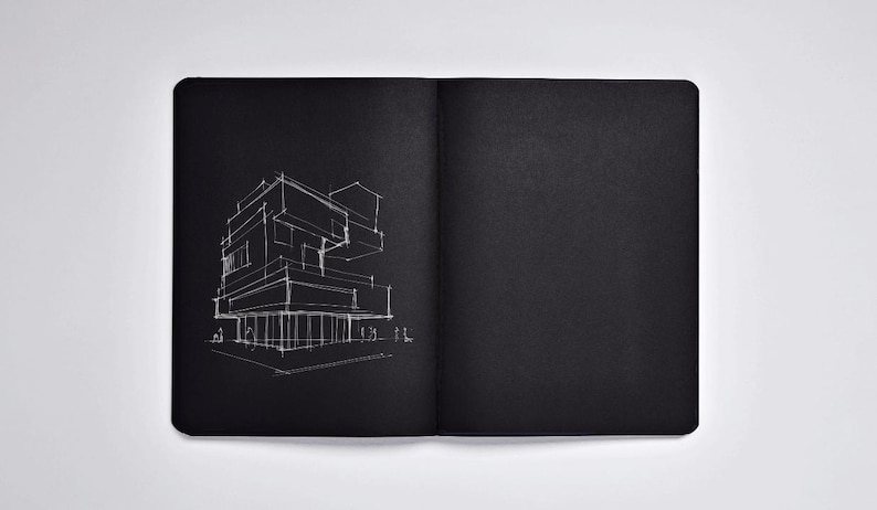 May include: Open black notebook with a white architectural sketch on the left page. The sketch depicts a modern building with geometric shapes and lines. The right page is blank.