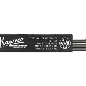 May include: A black box of Kaweco pencil refills. The box has white text that reads "Original Ersatzminen", "Refills", "Mine de Reserve", "Mina de Recambio", and "Mina di Ricambio". The box also has a white logo that reads "Kaweco" and "License to Write Germany Since 1883".