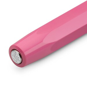 May include: Close-up of a pink fountain pen. The pen has a glossy finish and a geometric design. The end of the pen features a silver emblem. The pen is set against a white background.