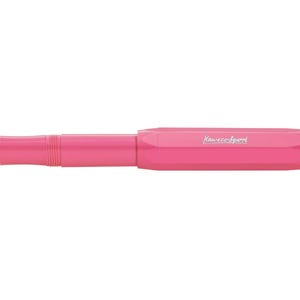 May include: A bright pink fountain pen with a silver nib. The pen has a sleek, modern design with the brand name "Kaweco Sport" printed on the barrel. The pen is a vibrant color and is set against a white background.