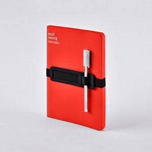 May include: A red notebook with a black elastic band and a white pen. The notebook has the text "NOT WHITE" printed on the cover.