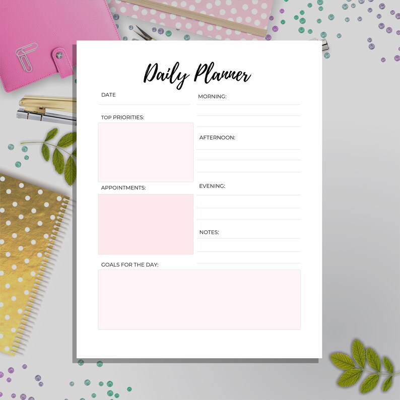 May include: A white daily planner with black text. The planner has sections for date, top priorities, appointments, goals for the day, morning, afternoon, evening, and notes.
