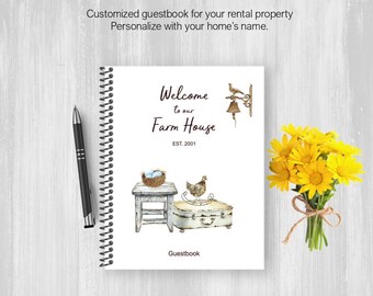 May include: A spiral-bound guestbook with a farmhouse theme. The cover reads "Welcome to our Farm House" with illustrations of a chicken, a small stool, and a suitcase. A black pen and a bouquet of yellow flowers are also present.