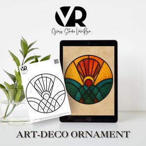 May include: An Art Deco ornament design displayed on a tablet and a printed template. The digital design features a colorful sunburst over green and blue hills. The printed template is black and white with numbered sections.