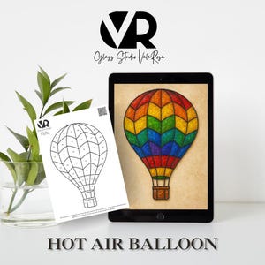 May include: A digital tablet displays a colorful hot air balloon design with a rainbow pattern. A black and white line drawing of a hot air balloon is on a white sheet of paper. The text "HOT AIR BALLOON" is at the bottom of the image.