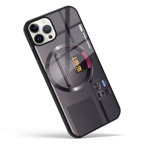May include: A black phone case with a Sega Genesis design. The case features a gray and silver Sega Genesis console with the text "16-BIT" and "MEGA DRIVE SEGA" printed on it.