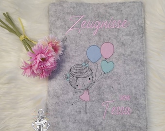 Certificate folder embroidered with girl's name, including clear sleeves.