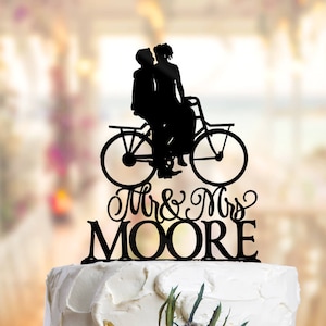 Bicycle Wedding Cake Topper where the Groom is on a bike and the Bride is sat on his lap. Bike Cake Topper, Cake Topper Bicycle PR111