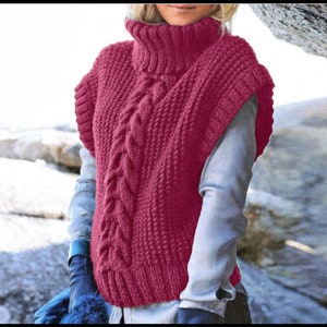 May include: A pink knitted sleeveless sweater with a high neck and a cable knit pattern.