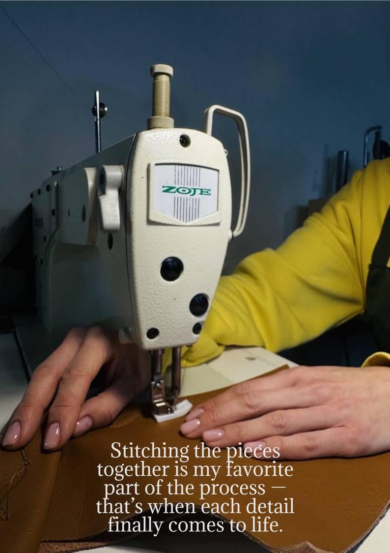 May include: A close-up of a cream-colored ZOJE sewing machine stitching brown leather. The text reads: "Stitching the pieces together is my favorite part of the process - that's when each detail finally comes to life."