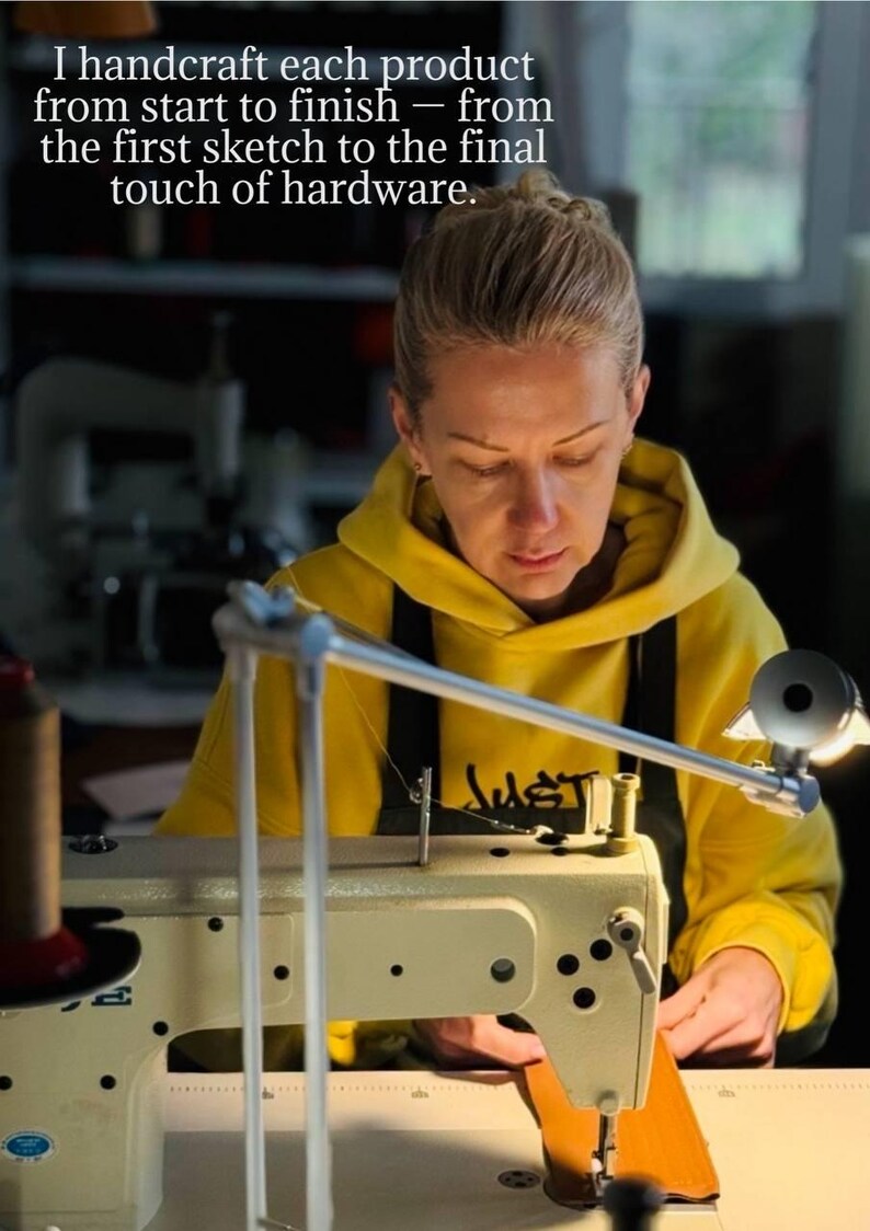 May include: A person in a yellow hoodie working on a sewing machine. The text in the image reads: "I handcraft each product from start to finish - from the first sketch to the final touch of hardware."