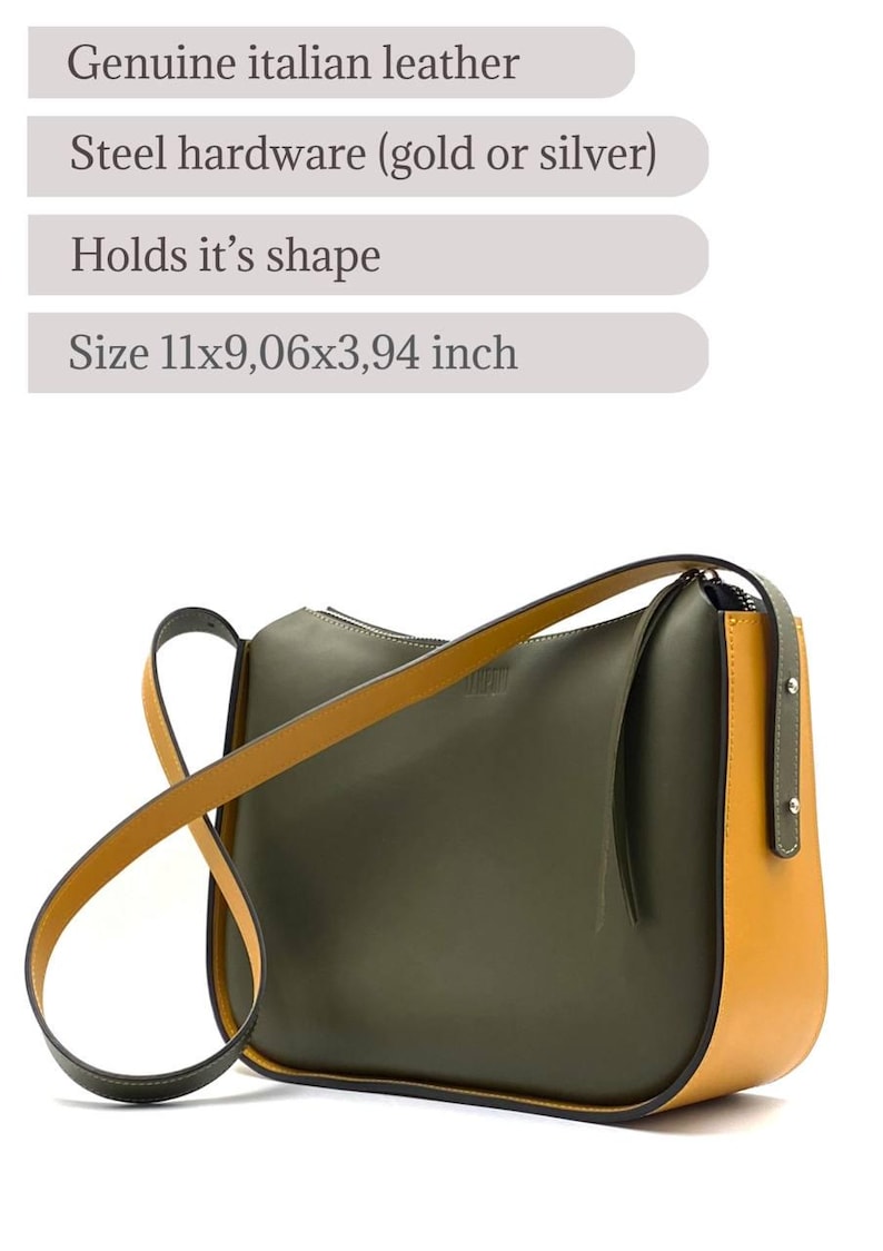 May include: A stylish olive green and mustard yellow leather shoulder bag. It has a curved design, a long strap, and steel hardware. Made from genuine Italian leather, the bag measures approximately 28x23x10 cm.