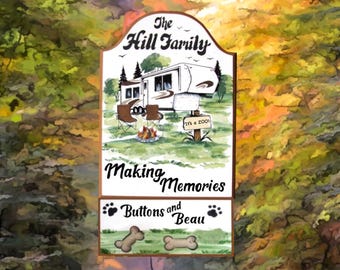 May include: A wooden sign with a painted image of a camper, a campfire, and two chairs. The text on the sign reads "The Hill Family Making Memories Buttons and Beau".