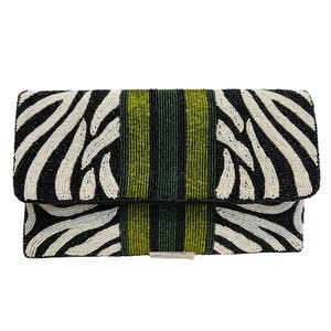 May include: A beaded clutch bag featuring a zebra stripe design in black and white, with a central green and black stripe. The rectangular bag has a fold-over flap and a silver-coloured clasp.