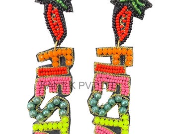 May include: A pair of beaded earrings spelling out the word "FUN". The earrings feature a black base with colorful beads in orange, red, pink, green, and yellow. The top of the earrings are shaped like a carrot with green leaves.