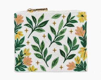 May include: White beaded clutch with a gold zipper. The clutch is decorated with a floral pattern of green leaves, yellow and pink flowers, and gold cross accents. The bag is rectangular in shape.