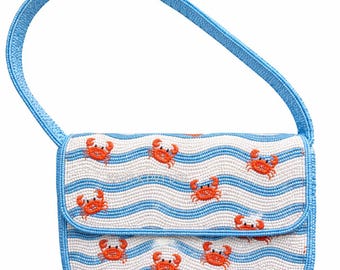May include: A beaded handbag with a blue handle and a flap closure. The bag features a white background with blue wavy stripes and orange crab designs. The edges and handle are blue.