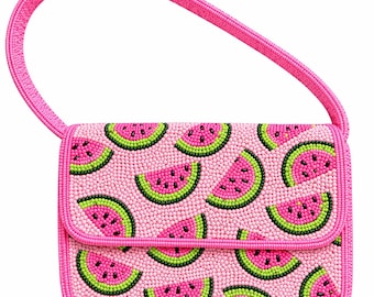 May include: Pink beaded handbag with a watermelon slice pattern. The bag features a flap closure and a matching pink handle. The watermelon slices have pink, green, and black details. The bag is approximately 8 inches wide.