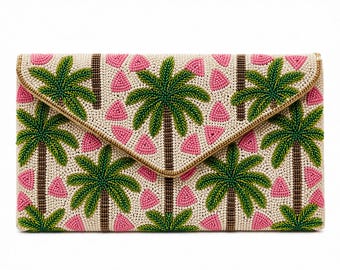 May include: Beaded clutch with a flap closure. The beige background is decorated with green palm trees and pink triangle shapes. The edges are trimmed with gold beads.