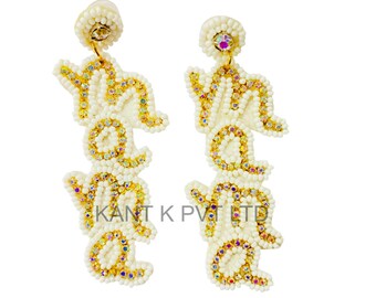 May include: A pair of white beaded earrings spelling out "YOLO" in gold-colored beads with iridescent accents. The earrings have a post back and are embellished with small, round beads. The text "KANT K PVT LTD" is printed on the earrings.