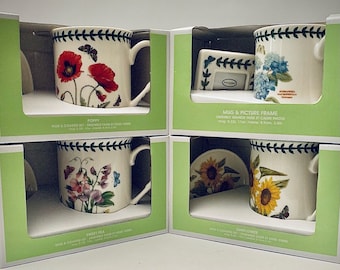 May include: Set of four mug and coaster sets featuring floral designs. Each set includes a white ceramic mug with a floral pattern and a matching coaster. The designs include poppy, sweet pea, sunflower, and hydrangea.