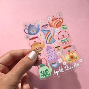 May include: A clear sticker with a colorful illustration of teapots and cups with flowers and the text "spill the tea".