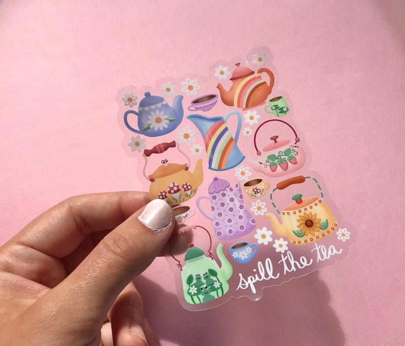 May include: A clear sticker with a colorful illustration of teapots and cups with flowers and the text "spill the tea".